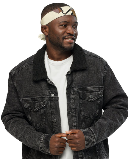 Homme souriant portant un bandana imprimé JOY & FREEDOM avec une veste en denim noire.